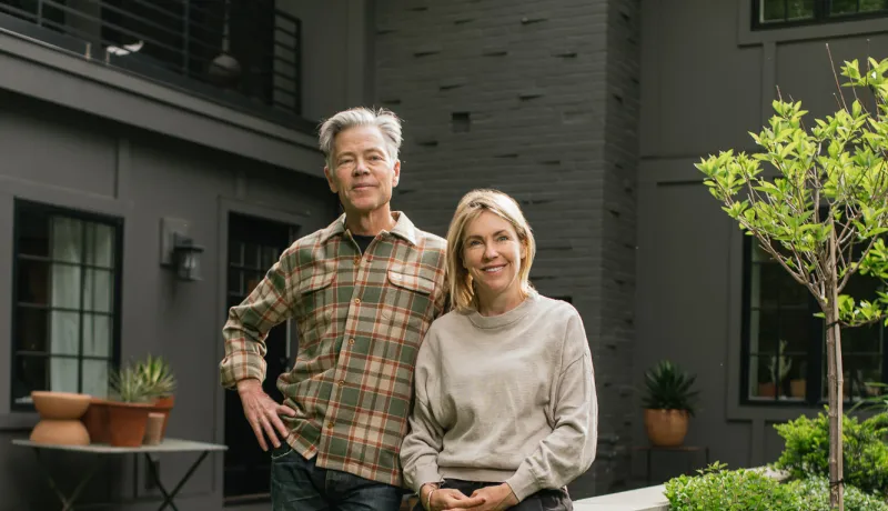 Jess and Jeff stand in front of their hybrid home in Golden Valley.