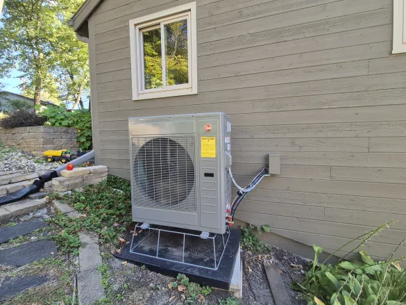 The Silbert family's air source heat pump next to the home.