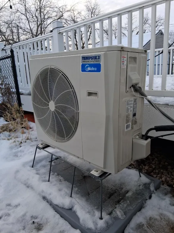 The Schneider family's air source heat pump outside their Rochester home.