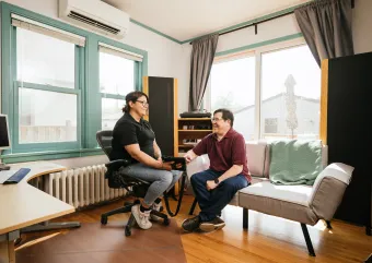 two people talking in a living room 