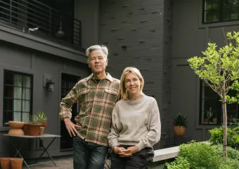 Jess and Jeff stand in front of their hybrid home in Golden Valley.