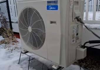 The Schneider family's air source heat pump outside their Rochester home.