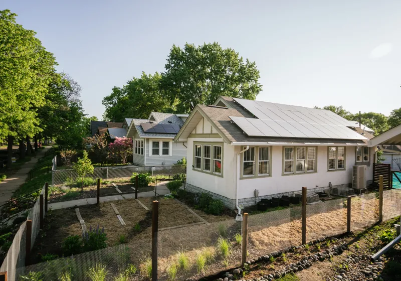 a house with a garden on a sunny day
