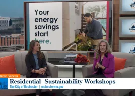 Two women sit on a couch for a TV news clip on energy efficiency.