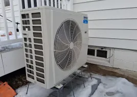 The Schneider family's air source heat pump outside their Rochester home.