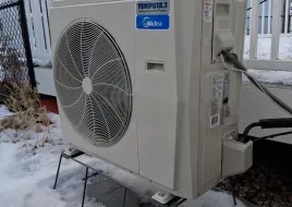 The Schneider family's air source heat pump outside their Rochester home.